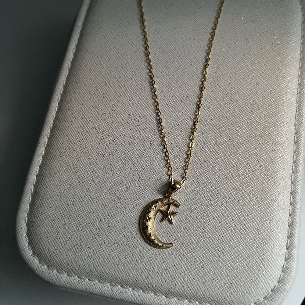 14kt gold pendant with 14kt gold 16” chain.